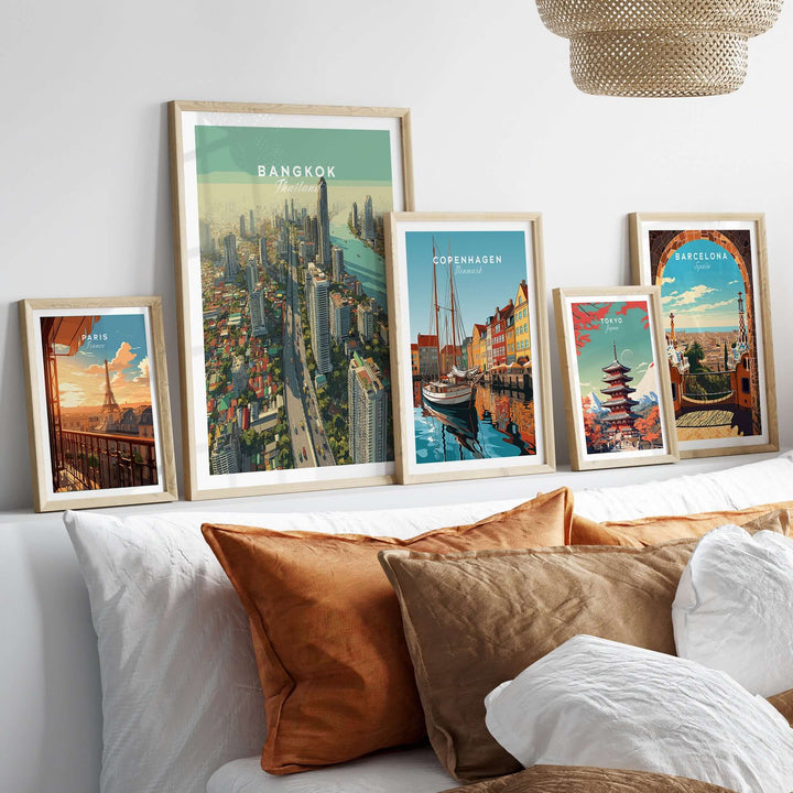 Bangkok city skyline poster alongside prints of Copenhagen and Barcelona on a stylish living room wall.