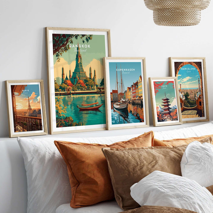 Framed travel posters featuring Bangkok's Wat Arun, Copenhagen, and Barcelona in a cozy living room setting.