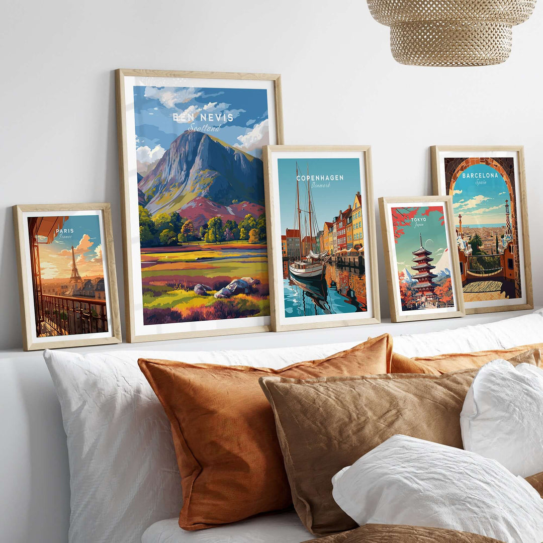 Vibrant Ben Nevis print alongside colorful cityscape posters in stylish frames on a cozy sofa backdrop.