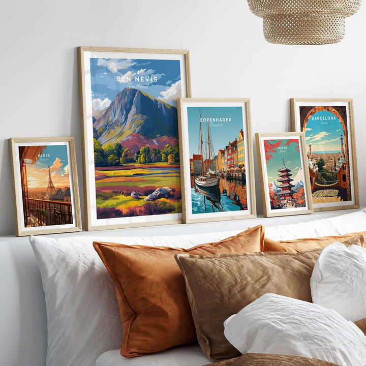 Vibrant Ben Nevis print alongside colorful cityscape posters in stylish frames on a cozy sofa backdrop.