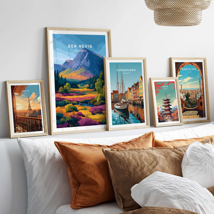 Gallery of travel posters including Ben Nevis, Copenhagen, and Barcelona displayed on a cozy sofa.