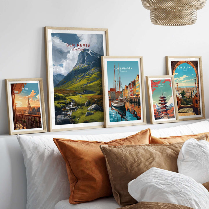 Framed art prints of Ben Nevis and city landscapes on a cozy sofa, showcasing Scottish and European scenery.