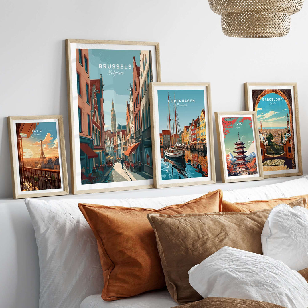 Wall display of framed city art prints featuring Brussels, Copenhagen, and Barcelona in a stylish modern interior.