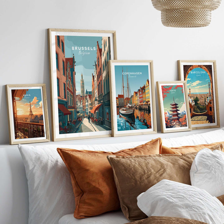 Wall display of framed city art prints featuring Brussels, Copenhagen, and Barcelona in a stylish modern interior.