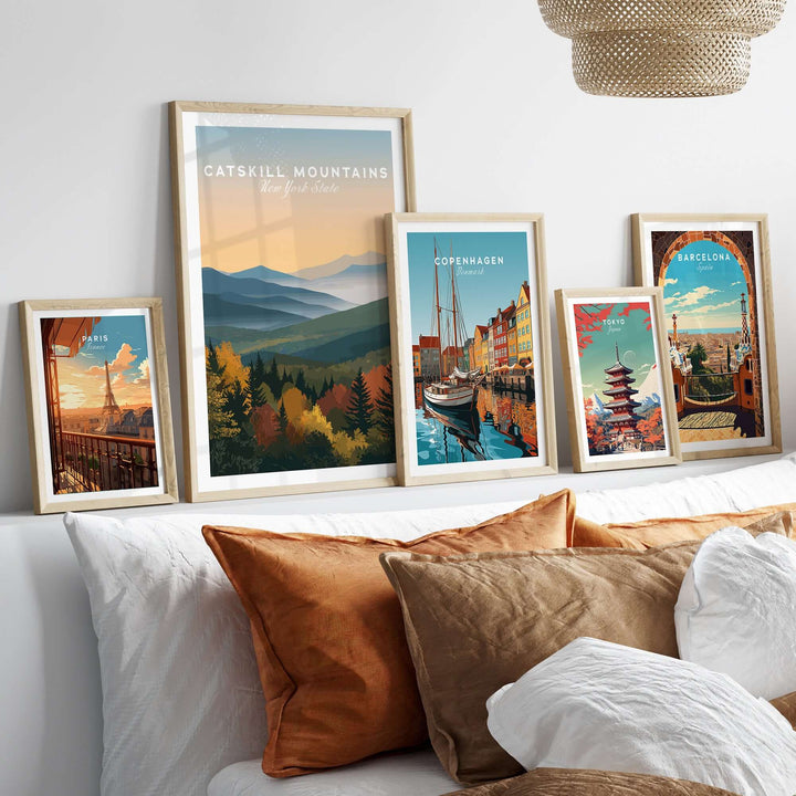 Framed wall art featuring Catskill Mountains and cityscapes of Copenhagen and Barcelona in a stylish interior setting.