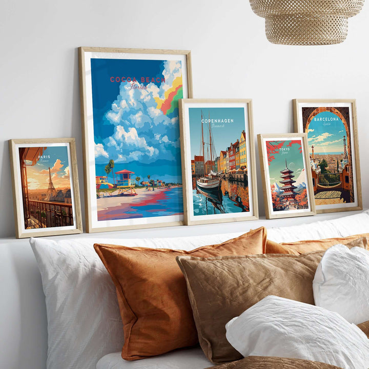 Framed Cocoa Beach Lifeguard Stand print and other city art on a stylish bedroom wall with decorative pillows.