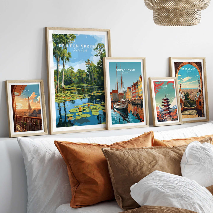 De Leon Springs Lily Pads wall art among other travel prints on a stylish sofa.