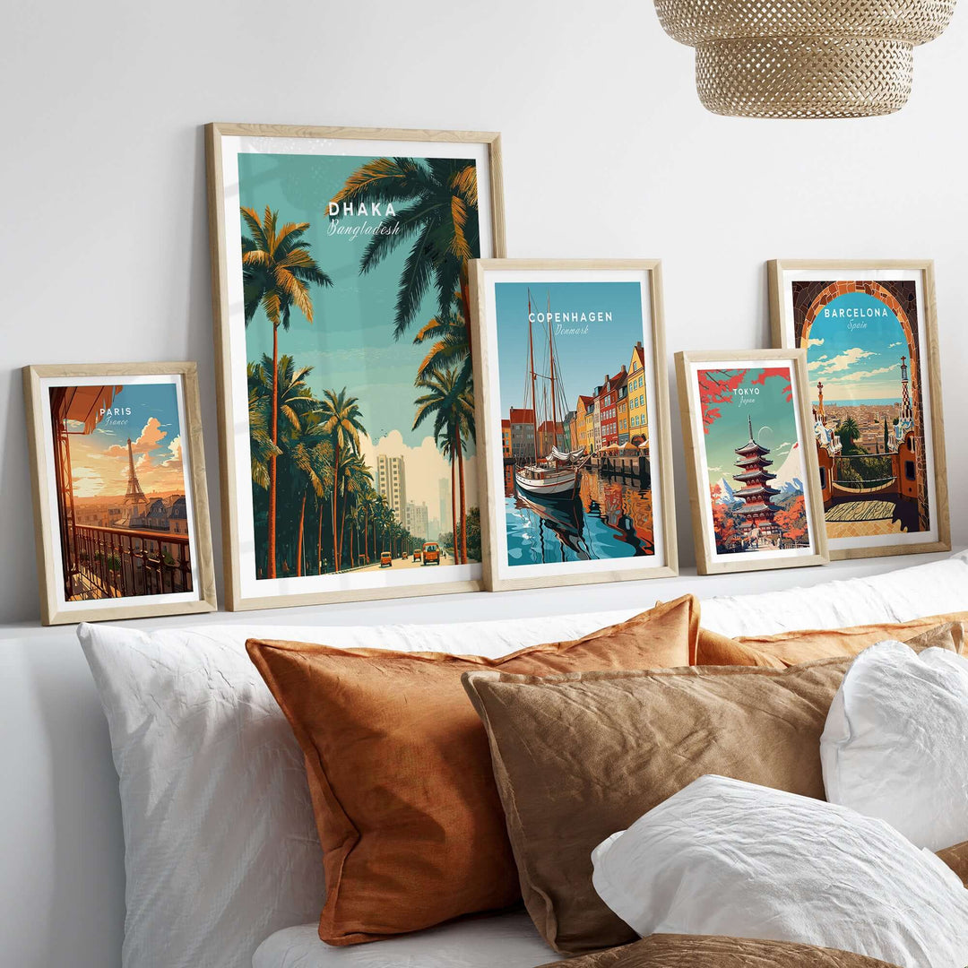 Colorful city life wall art prints of Dhaka, Copenhagen, and Barcelona displayed above a cozy sofa.