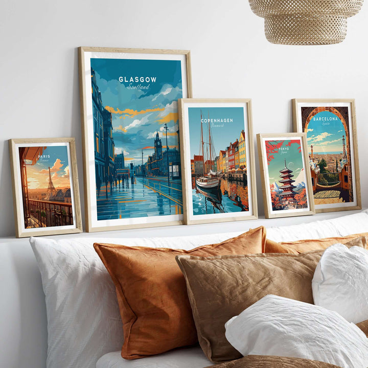 Various framed travel prints featuring Glasgow, Copenhagen, and Barcelona in a cozy interior setting.
