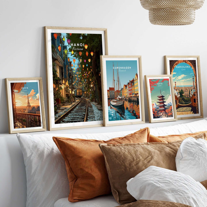 Hanoi Train Street print with vibrant lanterns displayed among framed city posters on a cozy sofa.