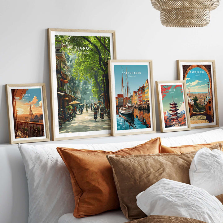 Hanoi Vietnam poster alongside city posters of Copenhagen and Barcelona, decor on a stylish bed with warm pillows.