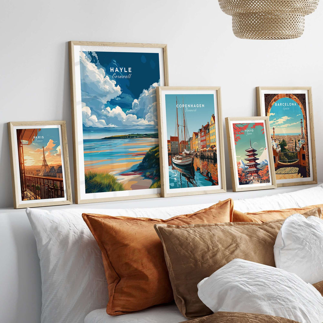 Framed Hayle ocean view print alongside travel posters of Copenhagen and Barcelona in a cozy living room setting.