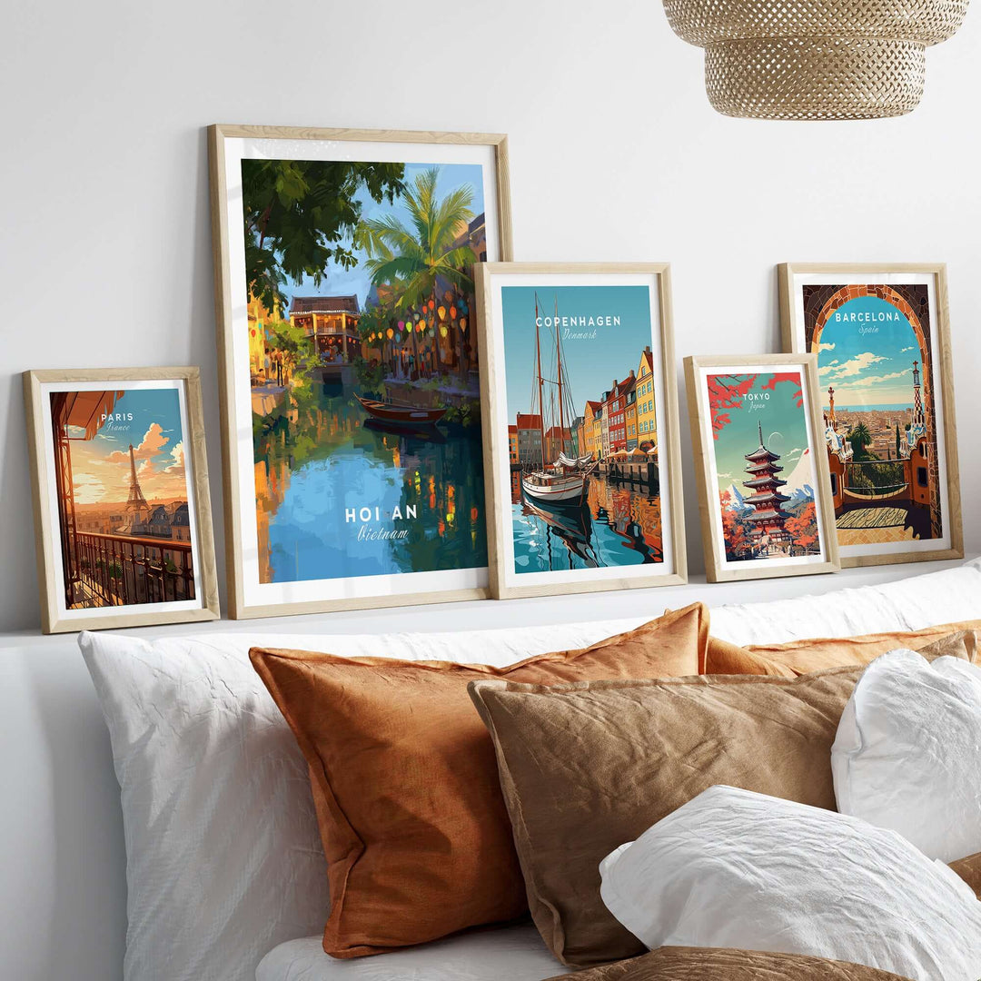 Framed art prints showcasing Hoi An, Copenhagen, and Barcelona against a cozy sofa backdrop.