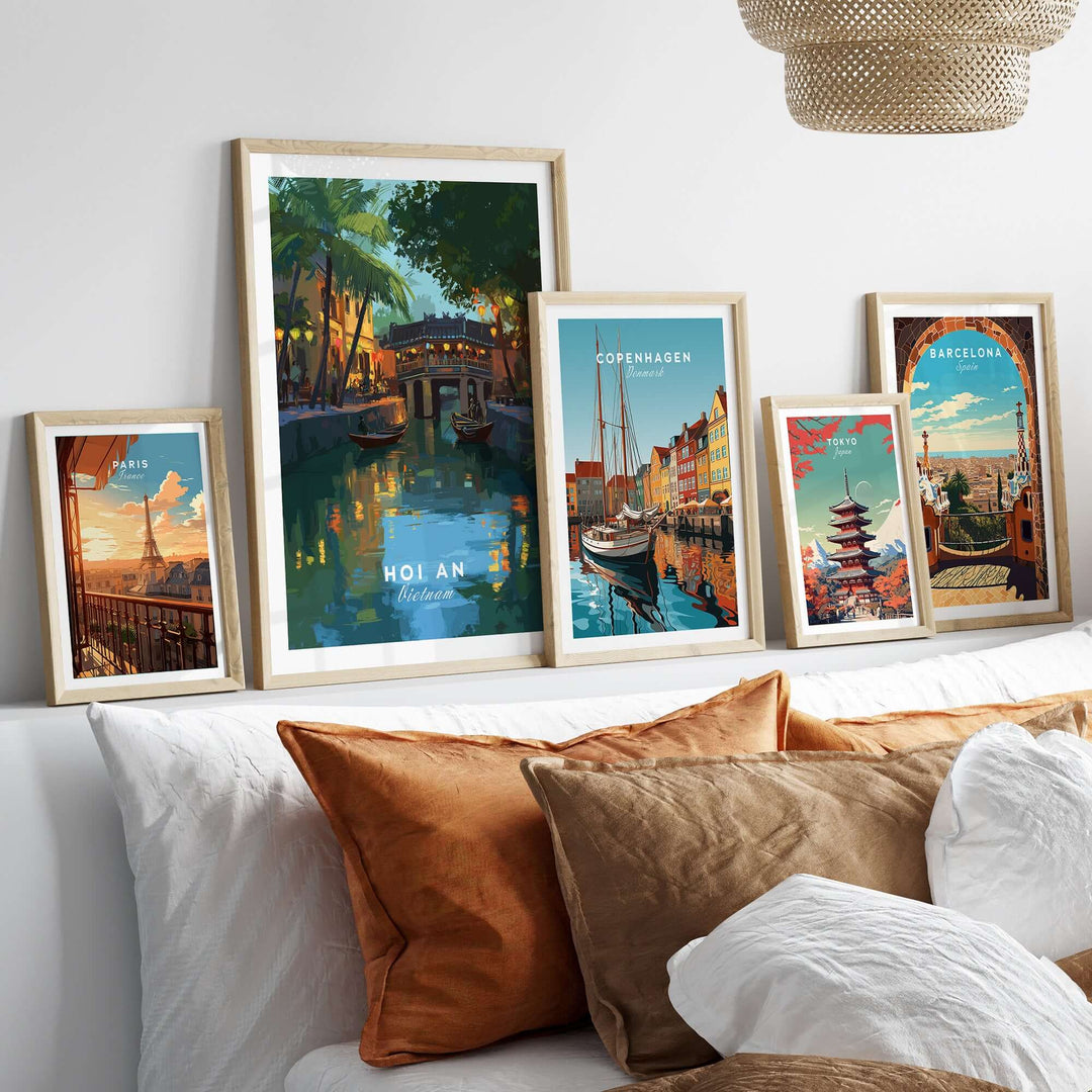 Gallery of travel posters featuring Hoi An, Copenhagen, Barcelona, displayed above a cozy bed with decorative pillows.