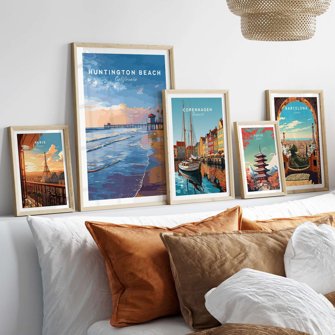 Framed wall art featuring Huntington Beach, Copenhagen, and Barcelona posters in a cozy living room setting.