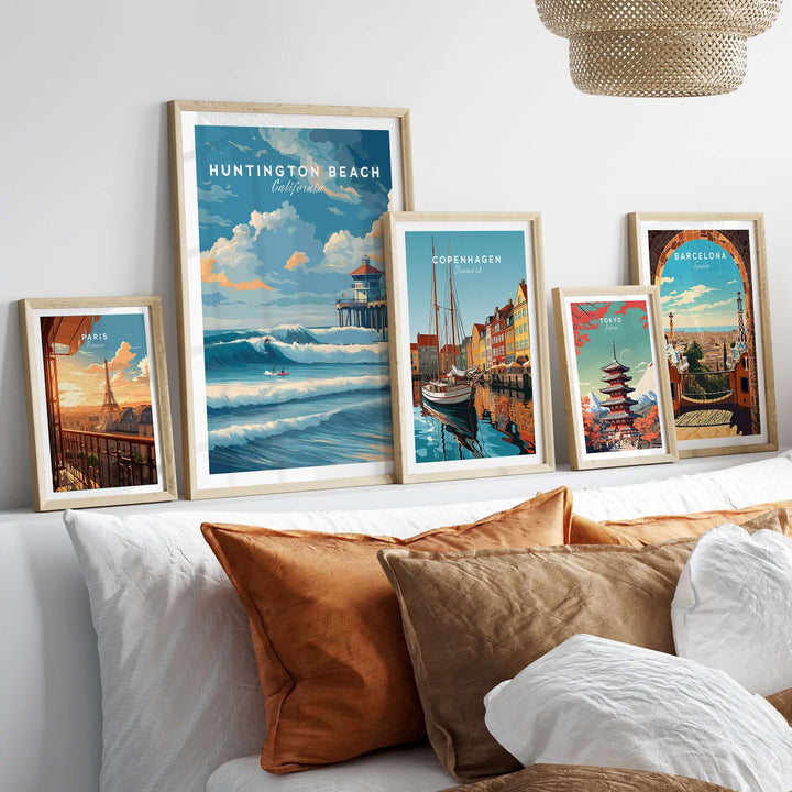 Huntington Beach Surfers Catching Waves print displayed among travel art in a cozy living room setting.