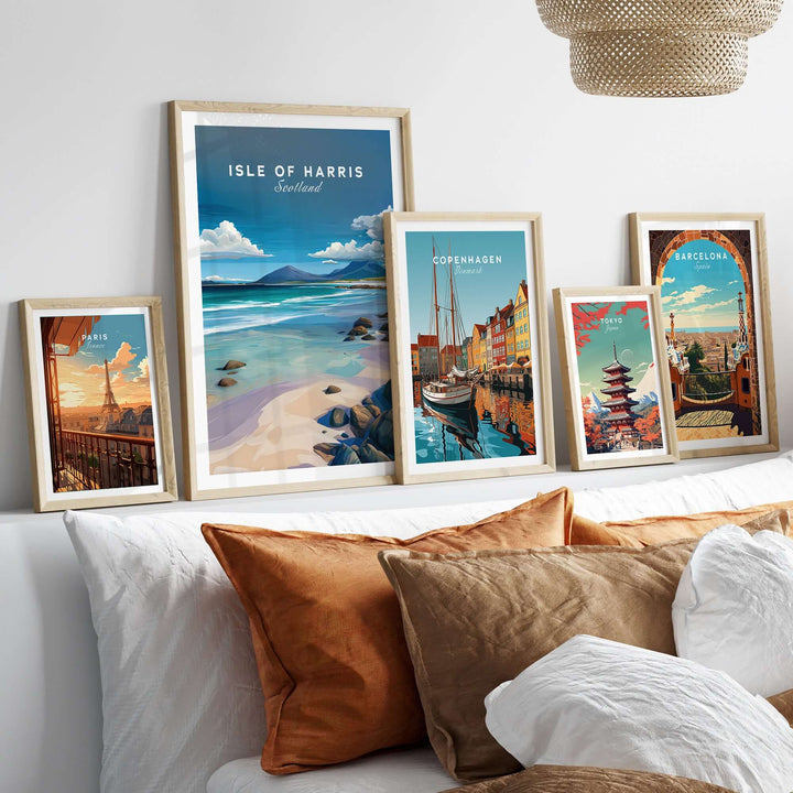 Framed wall art prints including Isle of Harris, Copenhagen, and Barcelona on a cozy sofa with pillows.