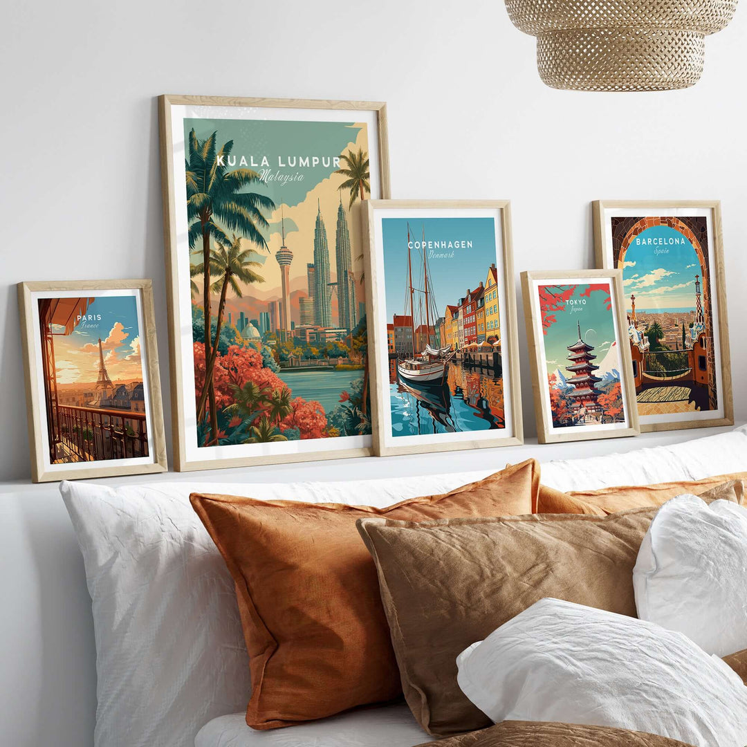 Framed cityscape prints showcasing Kuala Lumpur, Copenhagen, and Barcelona on a stylish wall above a cozy sofa.