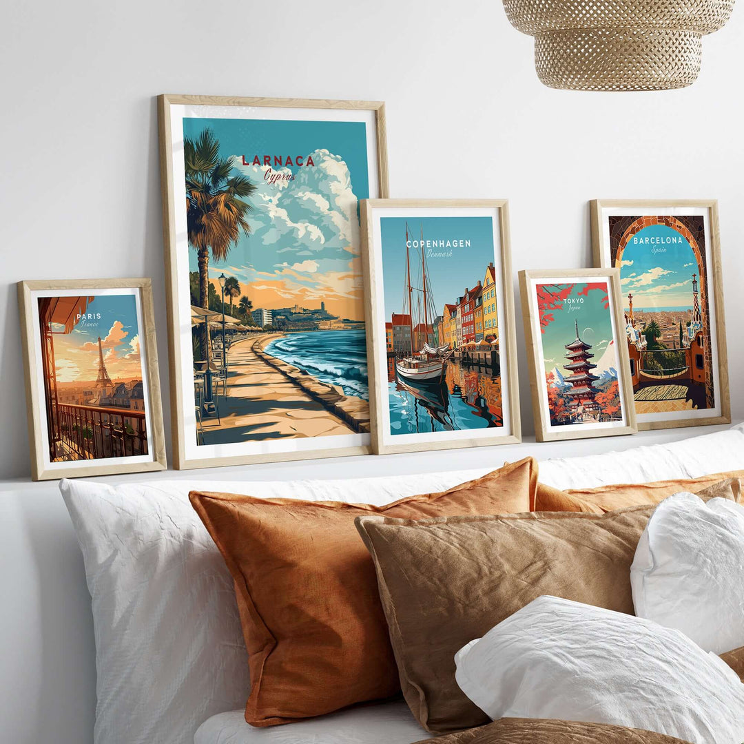 Larnaca and other city prints displayed in stylish frames on a bed, showcasing Mediterranean and coastal wall art.