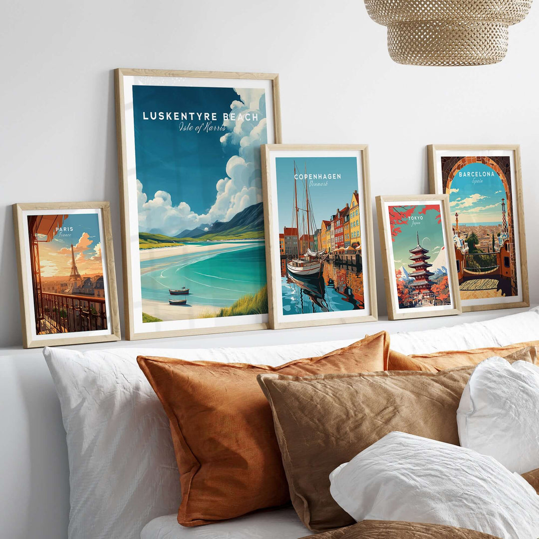 Framed Luskentyre Beach and city prints displayed on a stylish bed with decorative pillows.