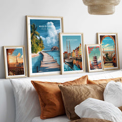 Maldives Travel Print - Beach Scene displayed among other travel prints in a stylish interior setting.