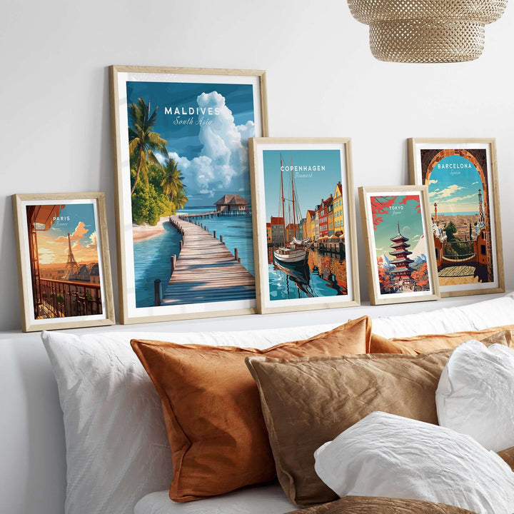 Maldives Travel Print - Beach Scene with framed artwork of tropical destinations on a cozy sofa.