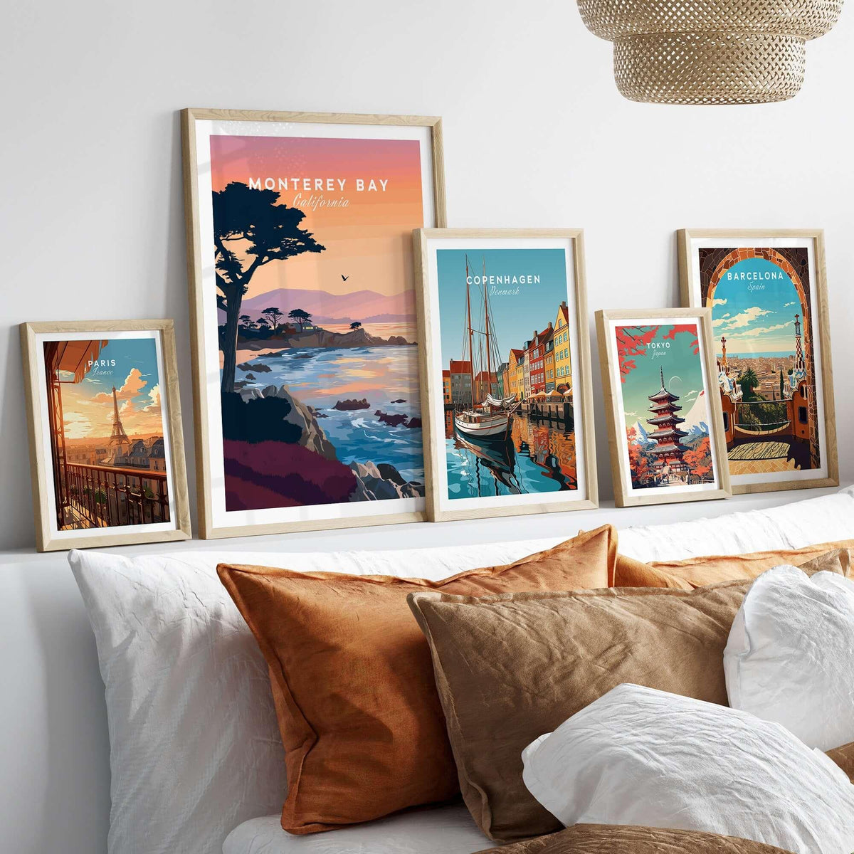 Monterey Bay California Sunset Coastline Poster - Cypress Tree Wall Art displayed with other travel posters on a cozy bed.