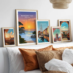 Monterey Bay California Print - Stunning Sunset Wall Art displayed in frames on a stylish bed with cozy pillows.