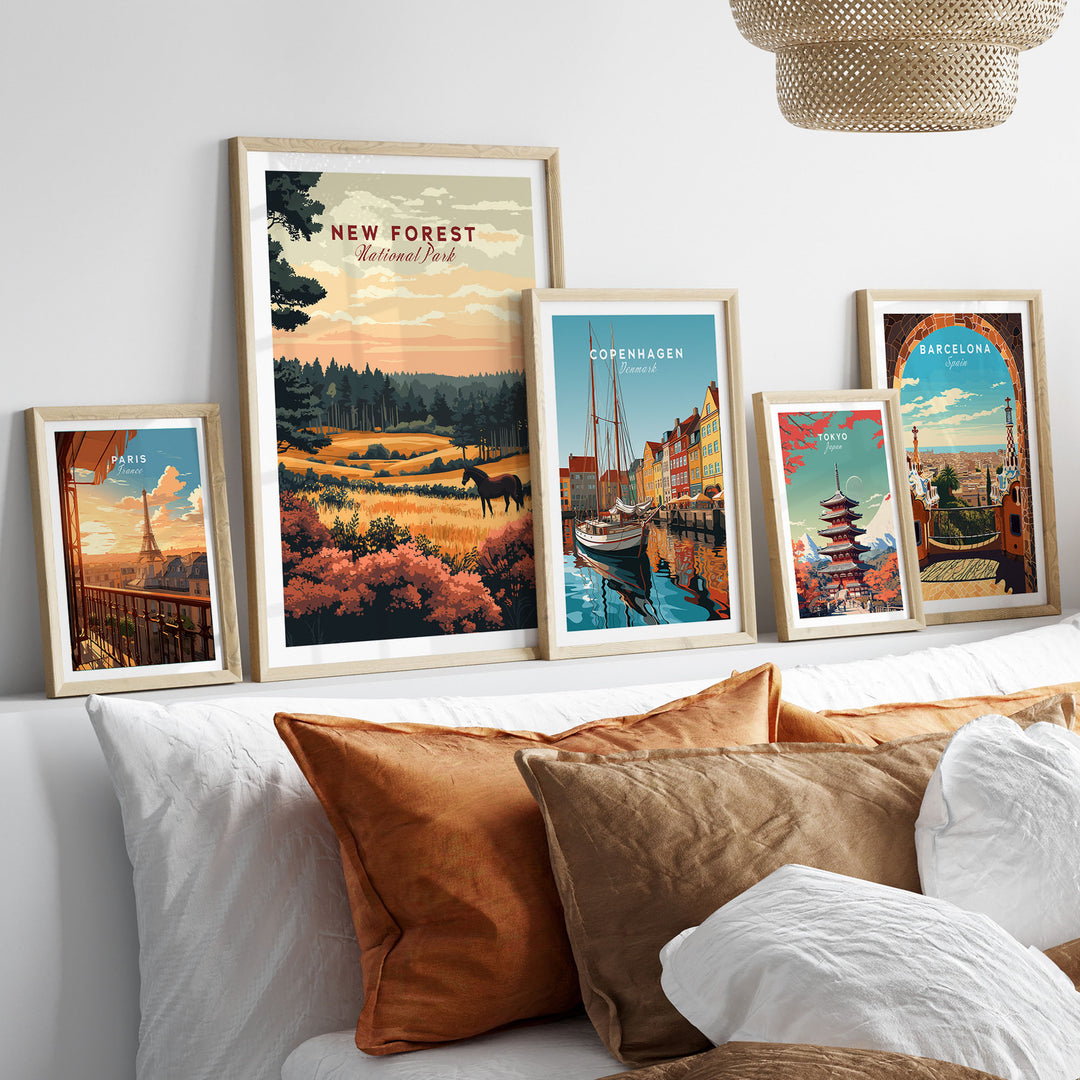 Gallery wall with framed New Forest National Park print and travel posters, showcasing nature and cityscapes in a cozy setting.