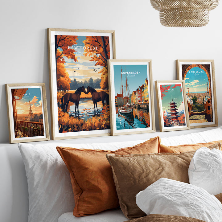 New Forest wall art print displayed with various framed city posters on a shelf above a cozy bed.