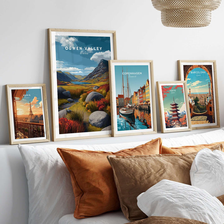 Ogwen Valley Wales print and colorful landscape posters displayed above a cozy couch with decorative pillows.