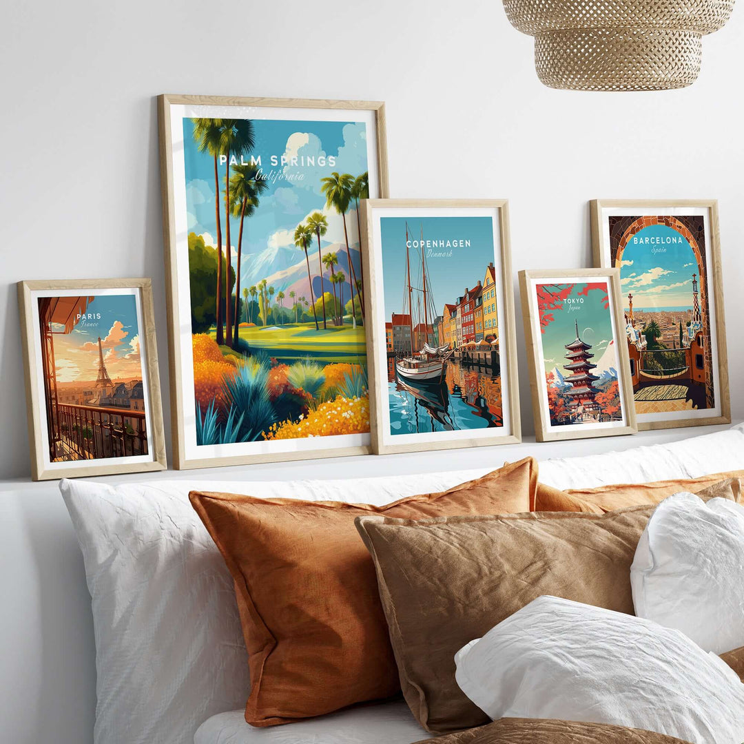 Elegant wall art collection featuring Palm Springs, Copenhagen, and Barcelona landscape prints on a stylish sofa.