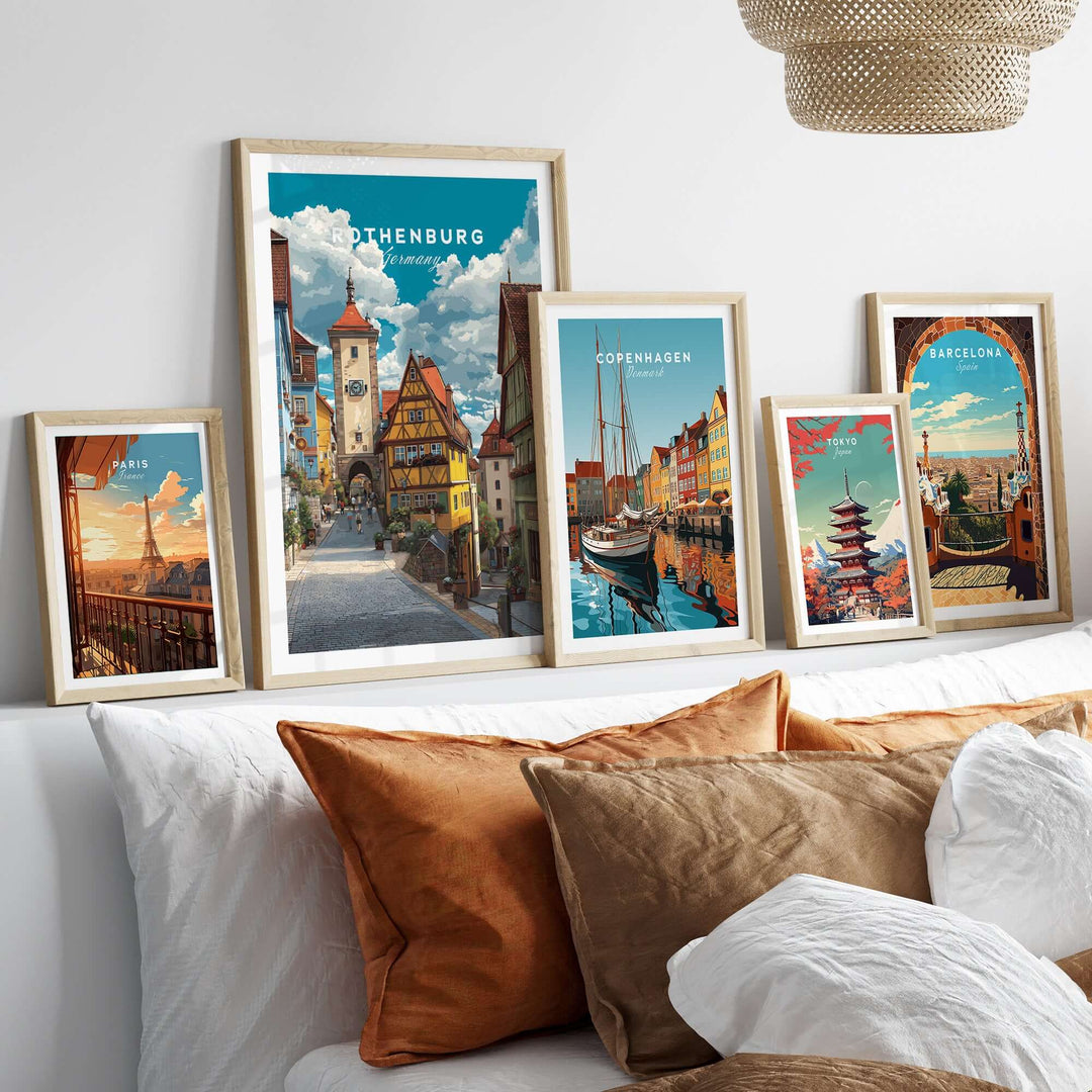 Rothenburg Germany travel poster surrounded by framed city prints on a cozy bed with decorative pillows.