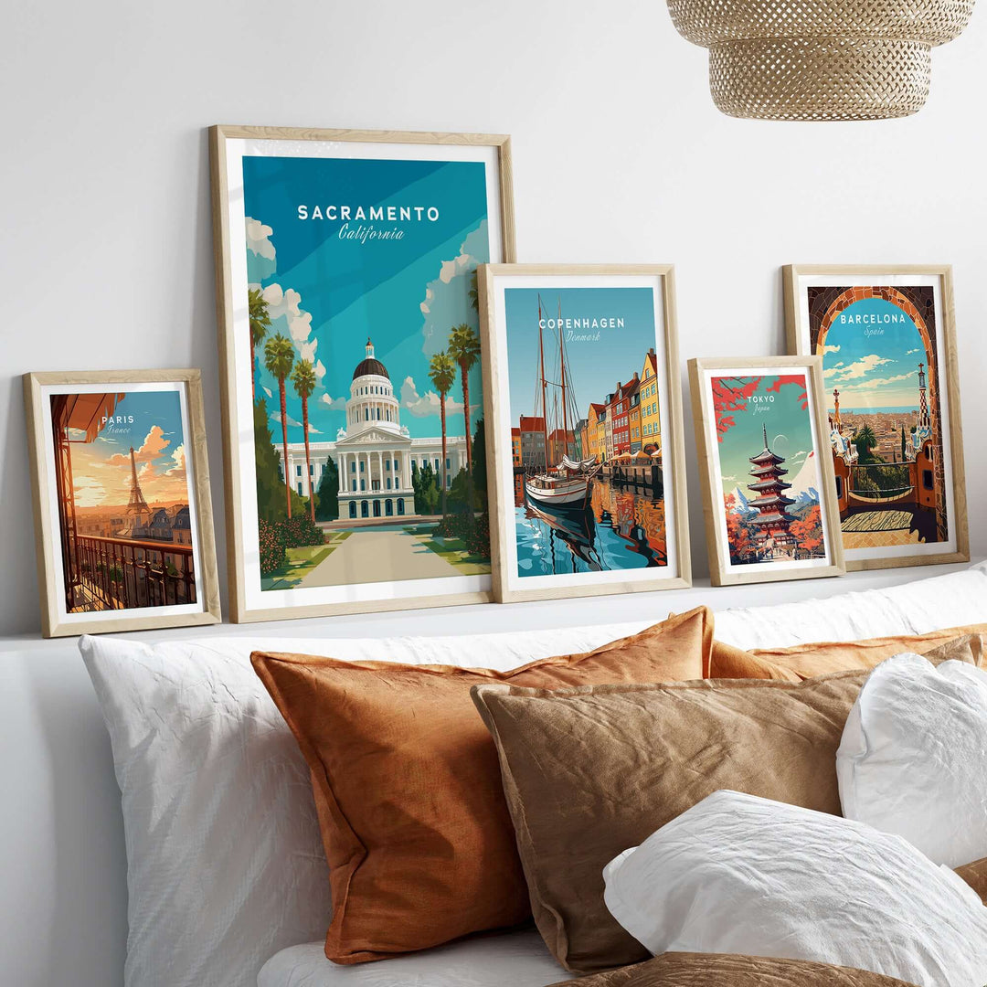 Framed Sacramento Capitol Building poster among travel art prints on a stylish bed display.