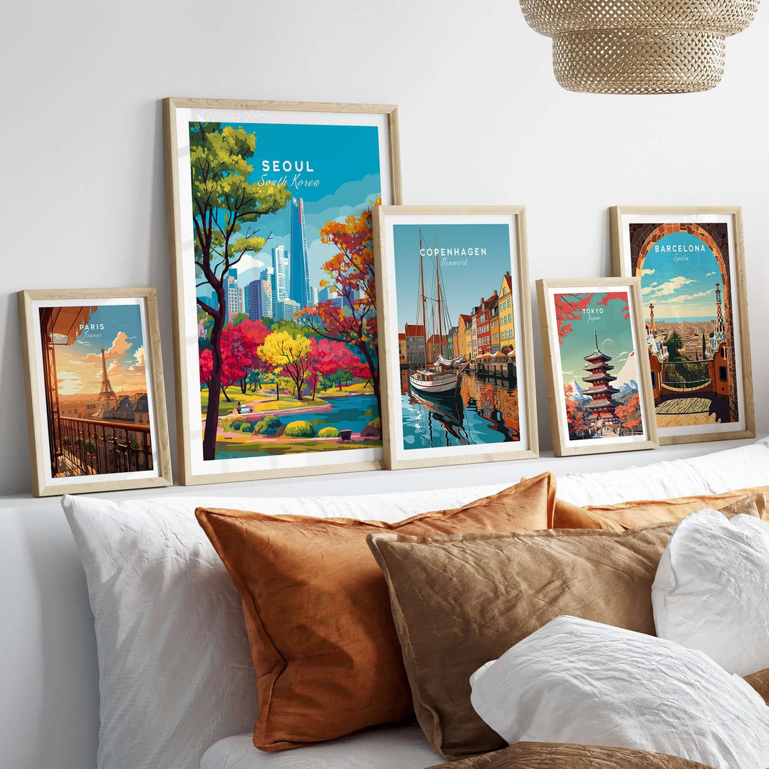 Framed prints showcasing Seoul, Copenhagen, and Barcelona cityscapes on a cozy sofa.