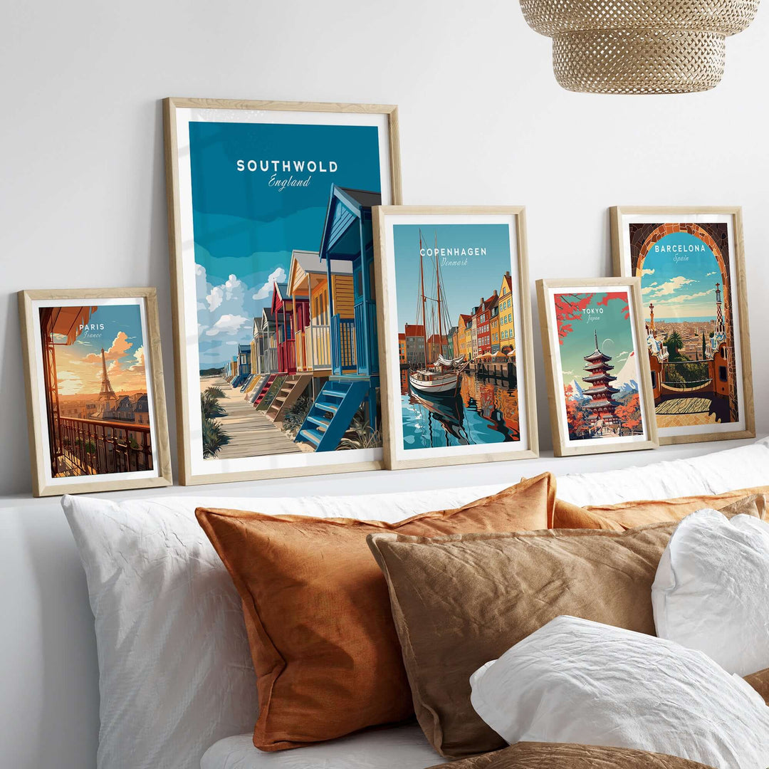 Framed prints of Southwold beach huts and coastal scenes, adding vibrant decor to a cozy living space.