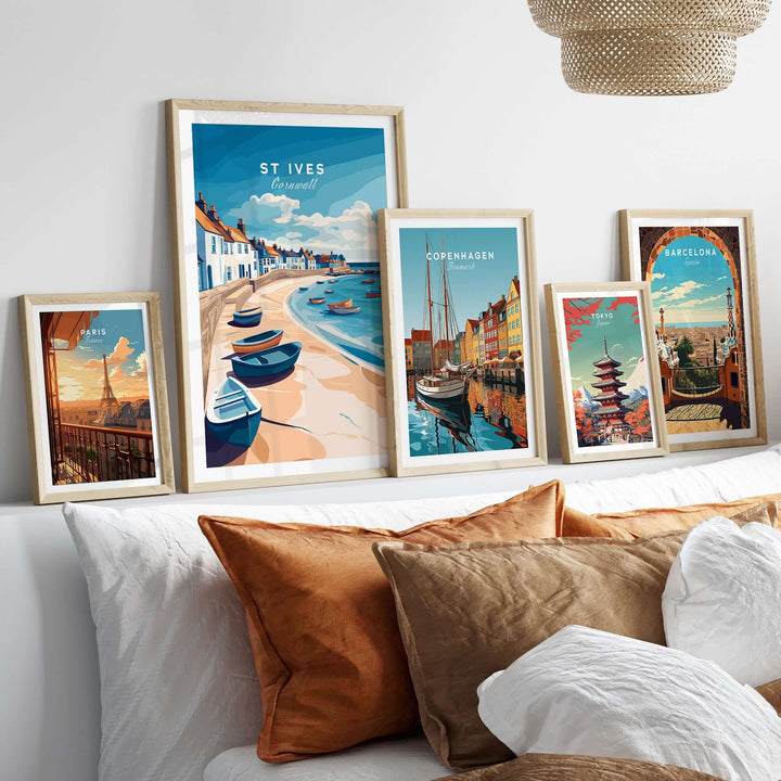 St Ives Beach Boats Seascape Poster and other city prints displayed on a cozy bed with decorative pillows.