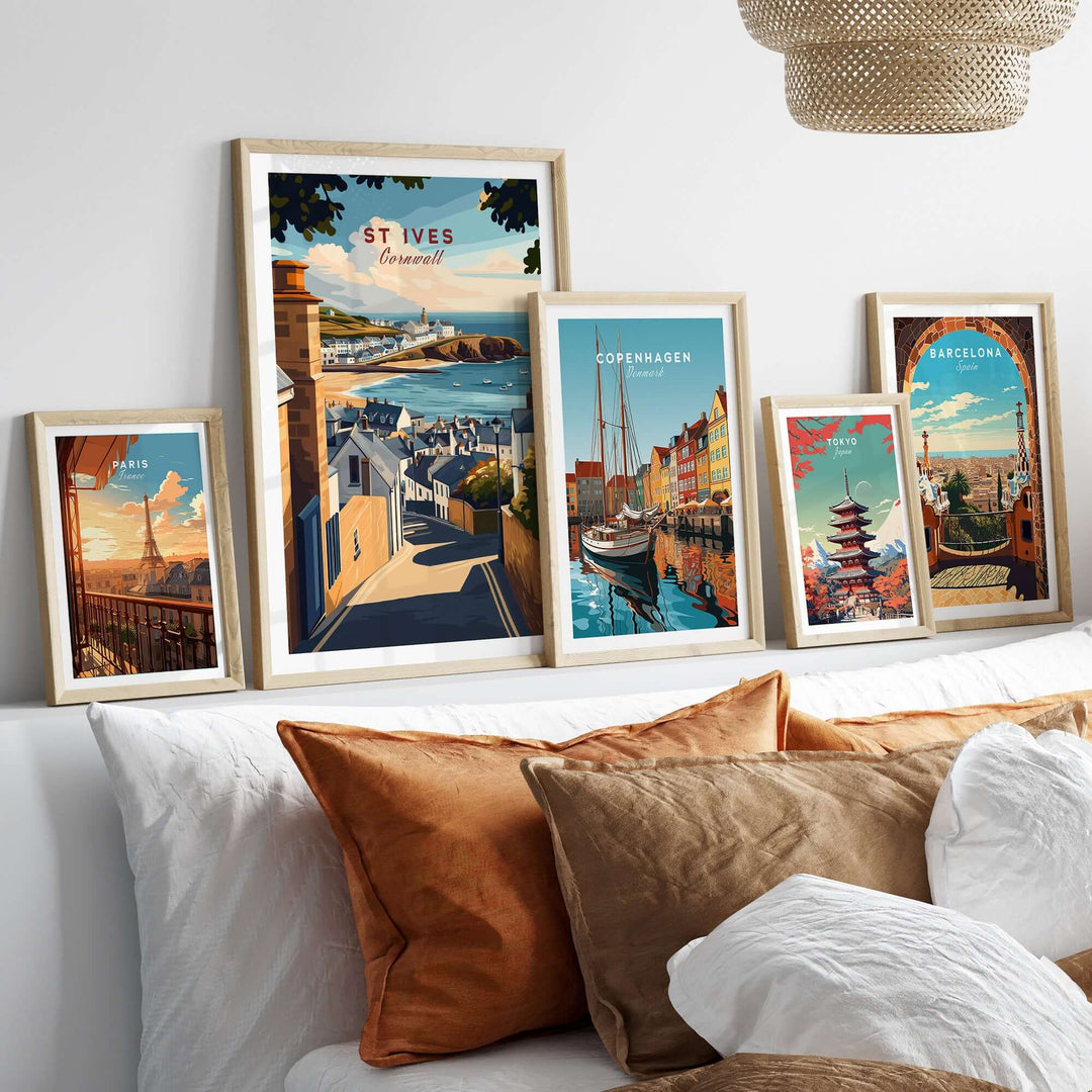 Framed wall art prints showcasing St Ives, Copenhagen, and Barcelona in a cozy living room setting.