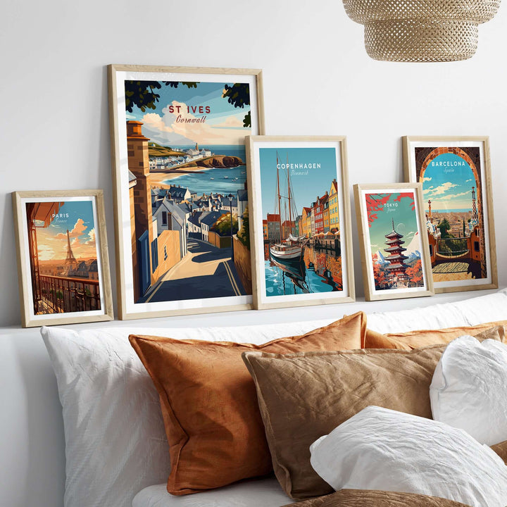Framed wall art prints showcasing St Ives, Copenhagen, and Barcelona in a cozy living room setting.