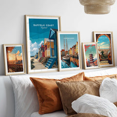 Suffolk Coast England Colorful Beach Huts Print - Vibrant Seaside Wall Art displayed in stylish frames on a sofa.