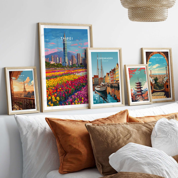 Colorful collection of cityscape prints, including Taipei 101 and landmarks from Copenhagen and Barcelona, displayed on a cozy sofa.