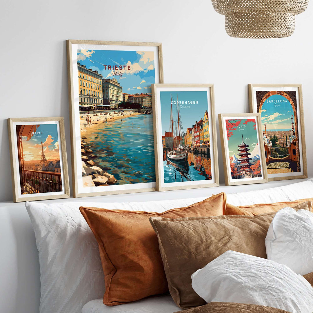Framed Trieste travel poster among other city prints, showcasing coastal charm and vibrant colors in a stylish home setting.