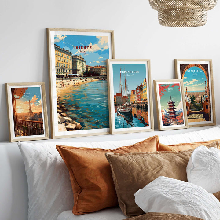 Framed Trieste travel poster among other city prints, showcasing coastal charm and vibrant colors in a stylish home setting.