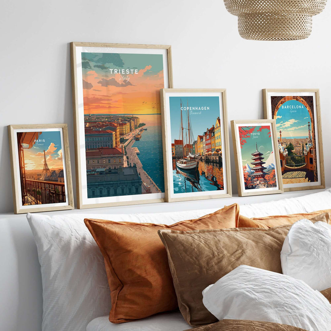 Framed coastal and city skyline posters of Trieste, Copenhagen, and Barcelona displayed above decorative pillows.