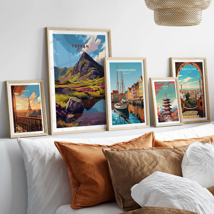 Framed mountain and city landscape prints including Tryfan, Copenhagen, and Barcelona on a stylish wall.