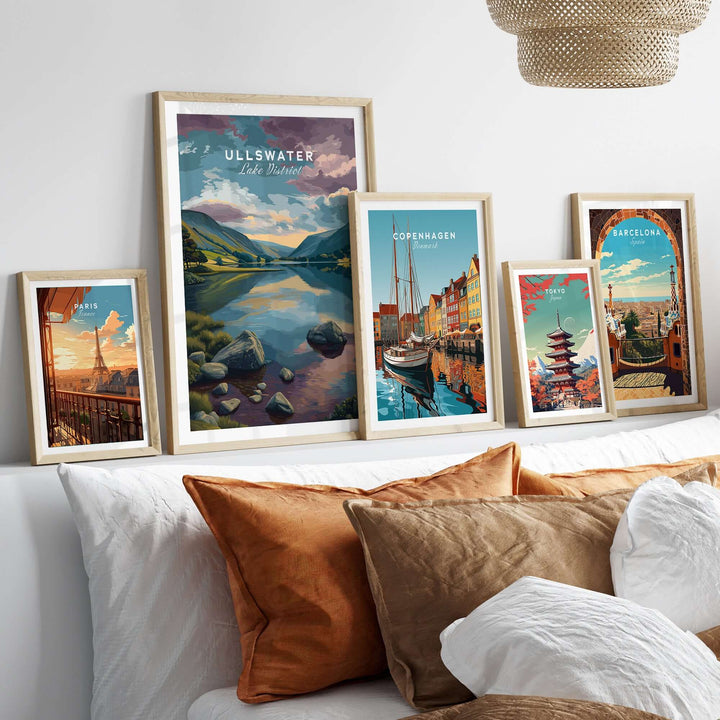 Ullswater Lake District sunset reflection print displayed among vibrant travel posters on a cozy bed setup.