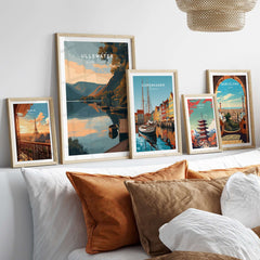 Ullswater Lake District Lakeside Boats Poster - Tranquil Dock Scene Print among framed travel posters on a cozy sofa.