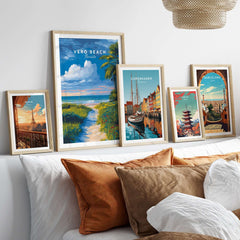 Vero Beach Florida Path to Beach Print - Coastal Flowers Wall Art displayed among other city prints on a stylish couch.