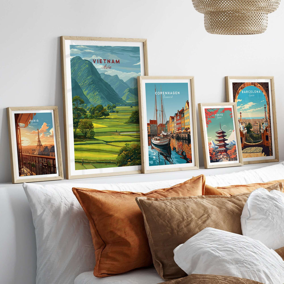 Vietnam rice fields landscape print and city posters arranged on a wall above a cozy sofa.