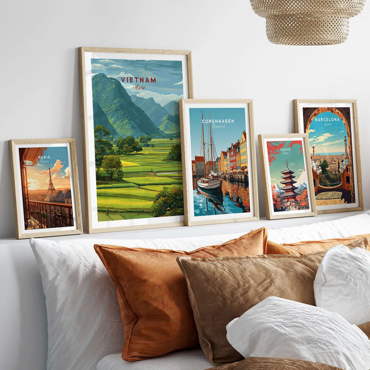 Vietnam rice fields landscape print and city posters arranged on a wall above a cozy sofa.